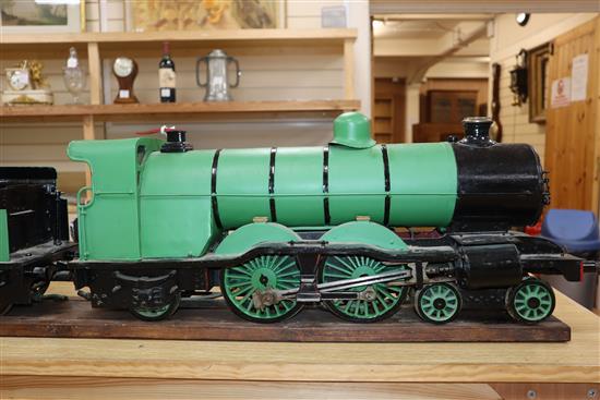 A 3.5 inch gauge 4-4-2 live steam locomotive and tender on wood stand, loco 27in. tender 18in.